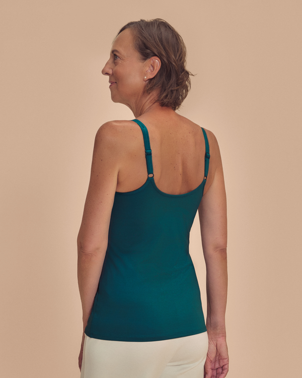 Valetta Mastectomy Pocketed Singlet top in Deep Emerald Green on a woman smiling back view